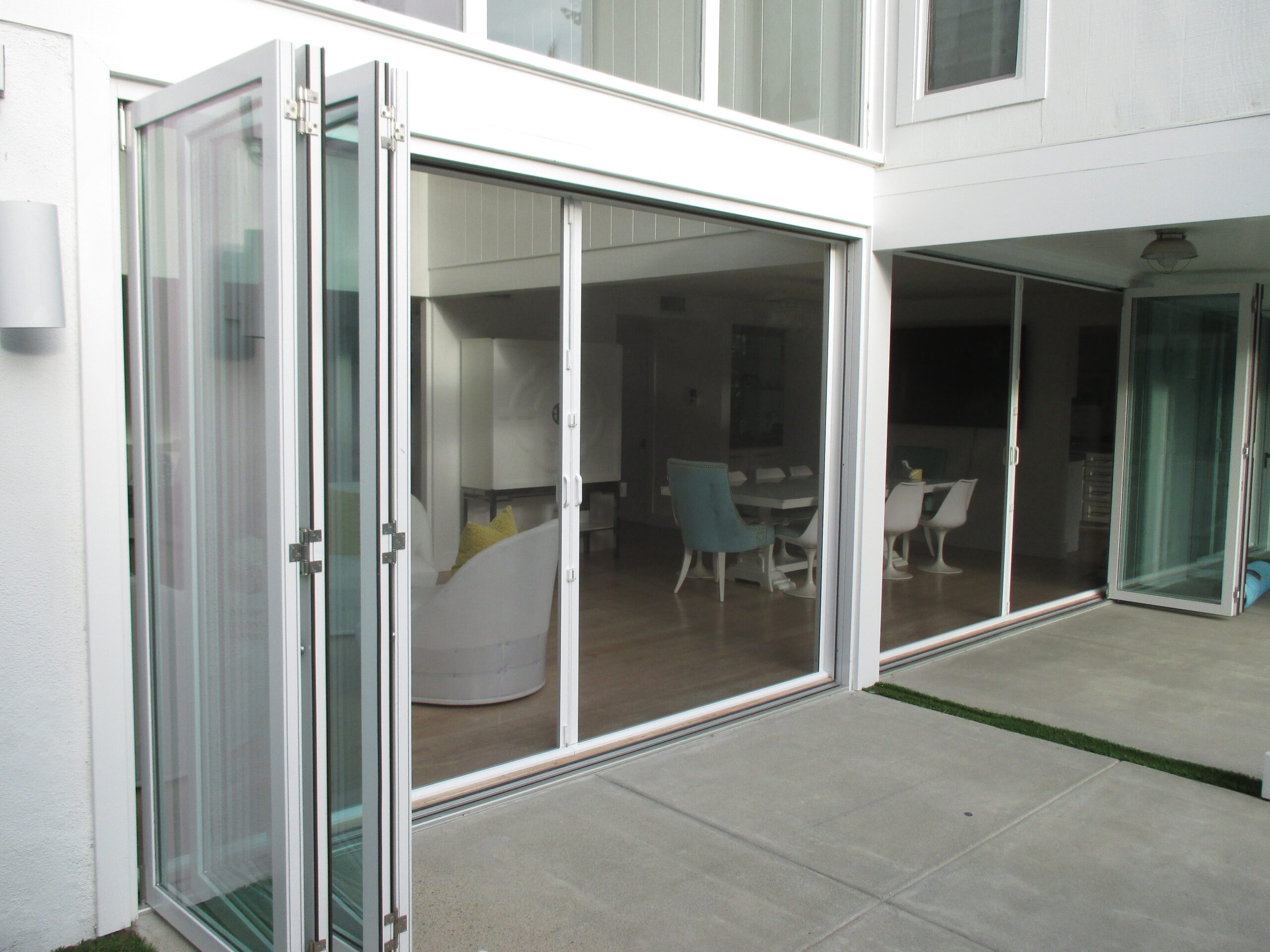 Patio doors to screened dining area, concrete patio.